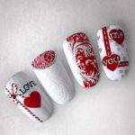 Бело-красный дизайн ногтей с изящными узорами надписями про любовь, бусинами и стразами