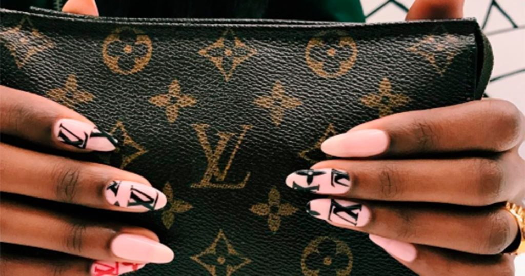 Ногти в розовом цвете с брендовым дизайном Louis Vuitton и надписями на двух ногтях