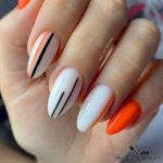 Оранжево-белый маникюр на ногти миндальной формы с полосками контрастного цвета