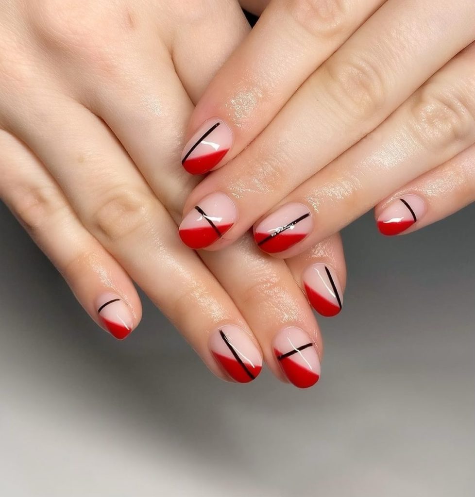 Красный френч со скошенными яркими кончиками и тонкими полосками в разных местах ногтей