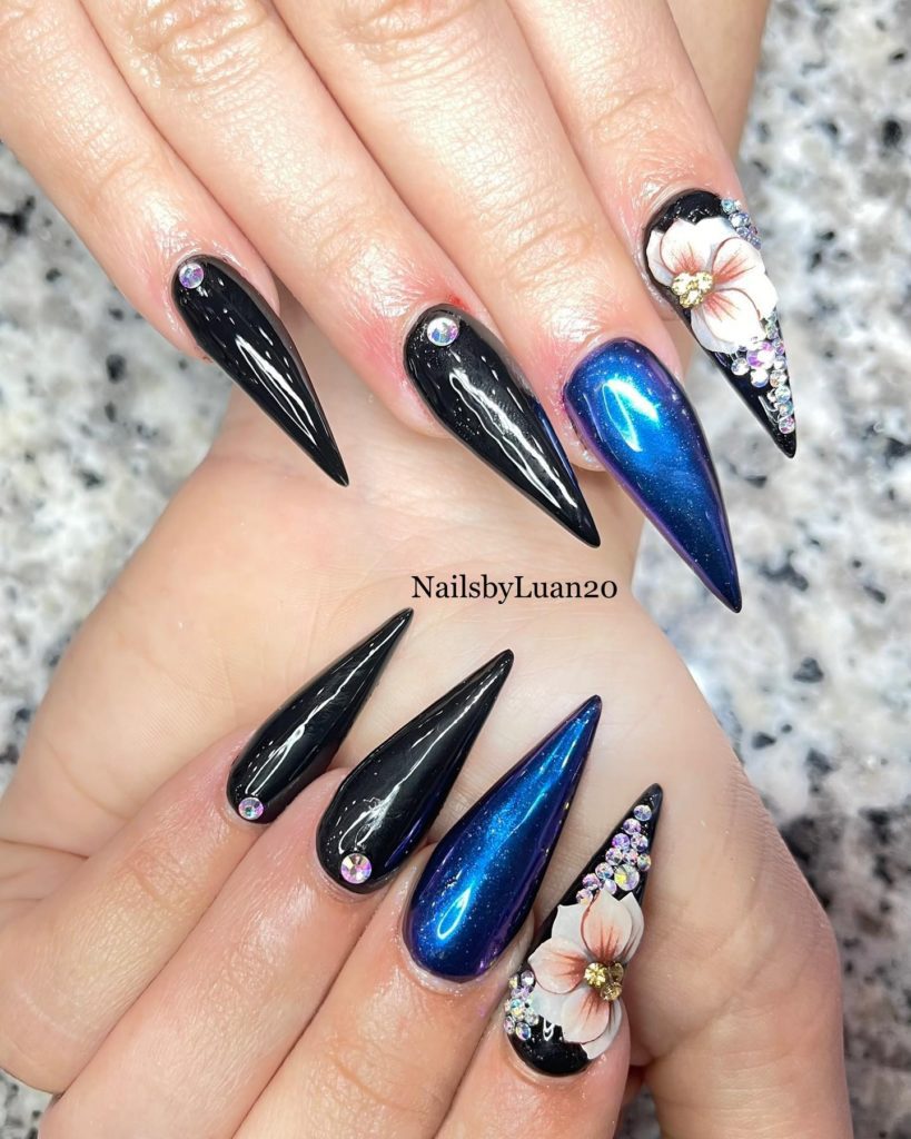 Маникюр на ногти-стилеты в черном и синем цвете с глянцевым покрытием, стразами, рисунками цветов