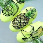 Матовый салатовый маникюр с объемными изображениями фруктов – лимона, ананаса, банана