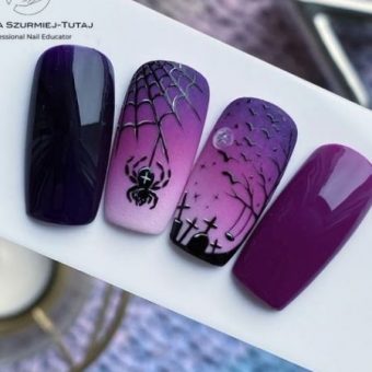 Дизайн ногтей в разных оттенках фиолетового цвета с черными рисунками в виде паука и кладбища