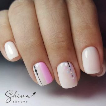 Нежно-розовое оформление ногтей с тонкими черными полосками, цветными вставками